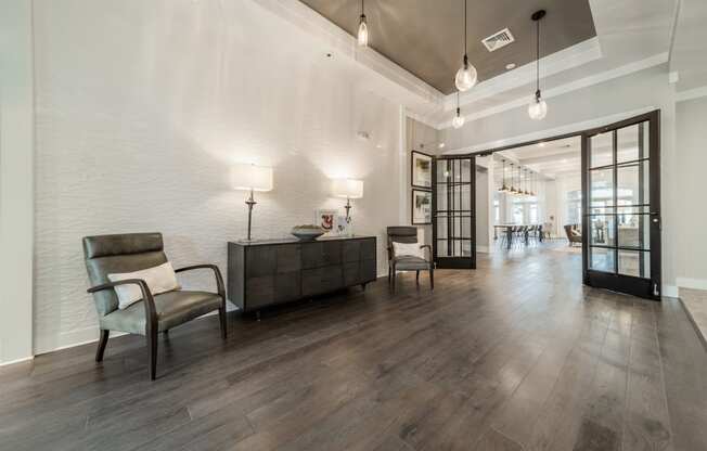 the preserve at ballantyne commons community lobby with chairs and tables and glass doors