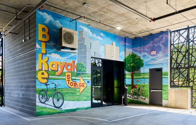 A mural on a wall with a bicycle and the words