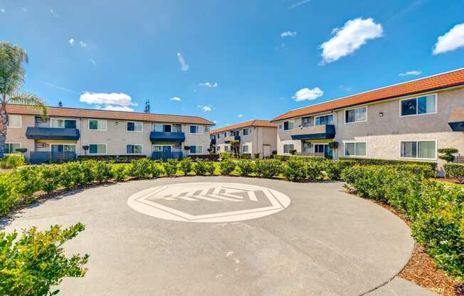 an image of an apartment building with a round driveway