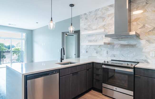 a kitchen with an island and a stove and a window