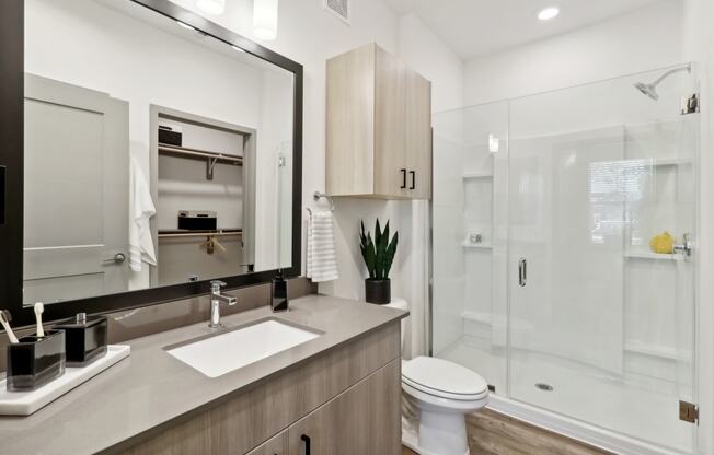 a bathroom with a sink toilet and a shower at The Depot in The Depot Raymore, MO 64083