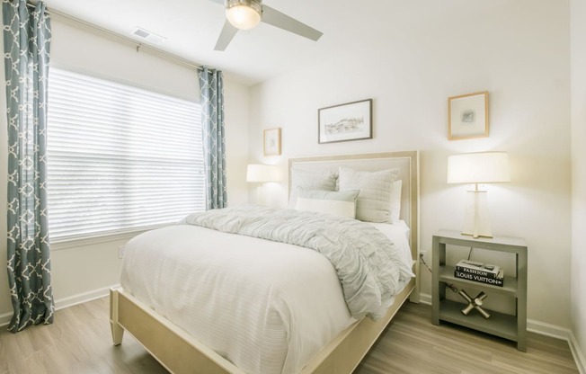 a bedroom with a bed and a ceiling fan