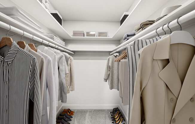a walk in closet filled with clothes and shoes