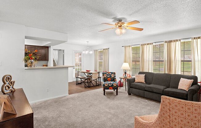 a living room with a couch and a ceiling fan