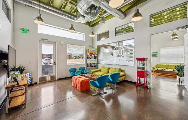 A modern office space with a variety of seating options and a view of the outdoors.