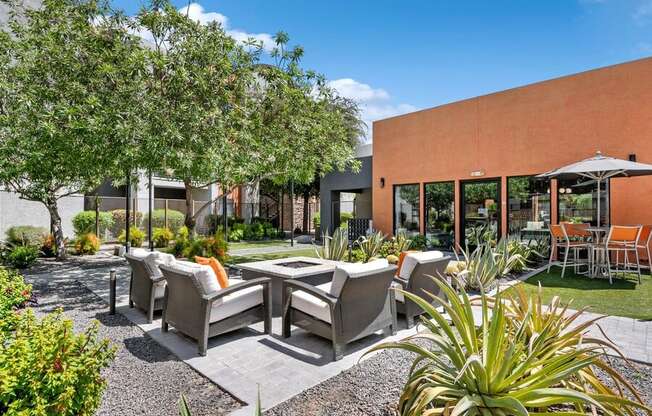 Community Fire Pit Area with Patio Furniture at Harmony at Surprise Apartments in Surprise, AZ.