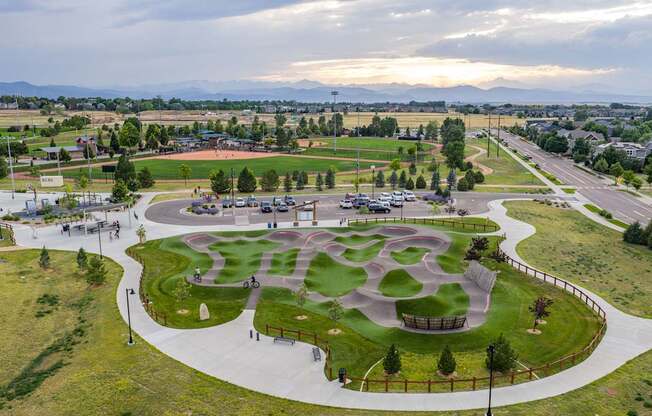 A park with a playground and a walking path.