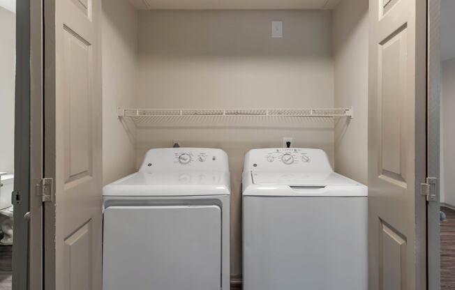 a washer and dryer in a laundry room with two white machines