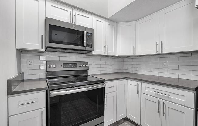 a stove top oven sitting inside of a kitchen