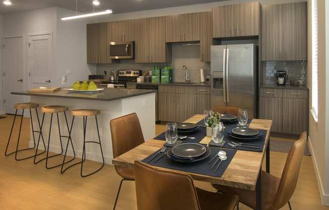 a kitchen and dining room with a table and chairs