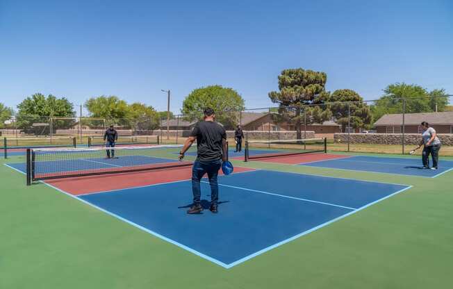 a group of people playing tennis on a tennis court