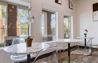 A dining room with a white table and chairs.
