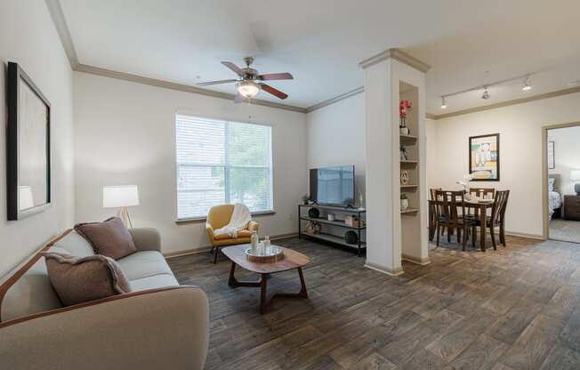 a living room with a couch and a ceiling fan