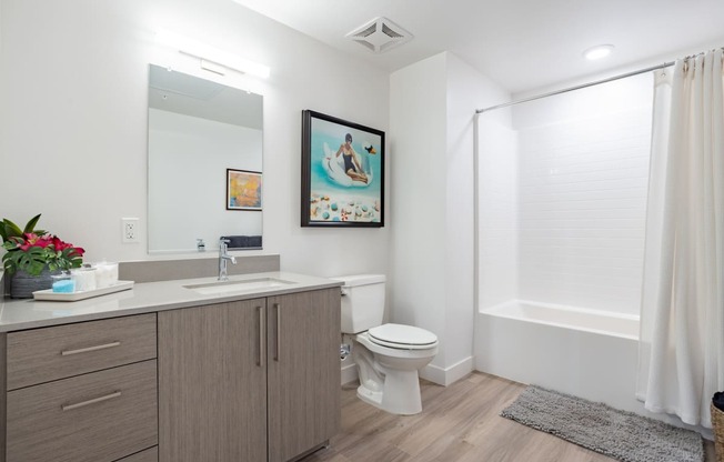 Bathroom with storage and tiled tub at The Chandler in North Hollywood