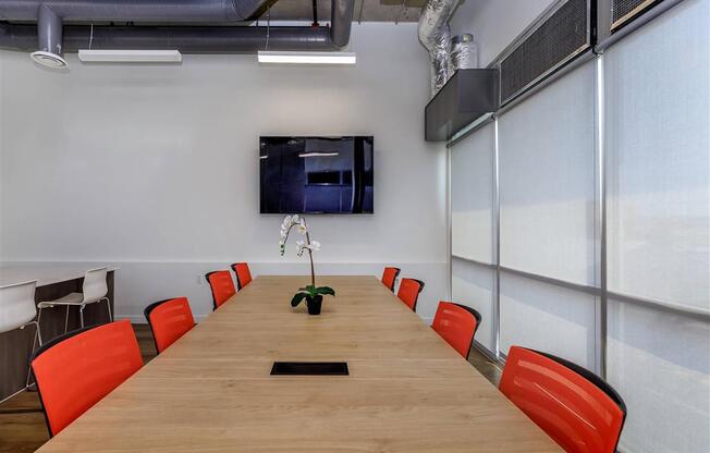 a conference room with a long table and orange chairs at Jefferson Yards, Tacoma Washington