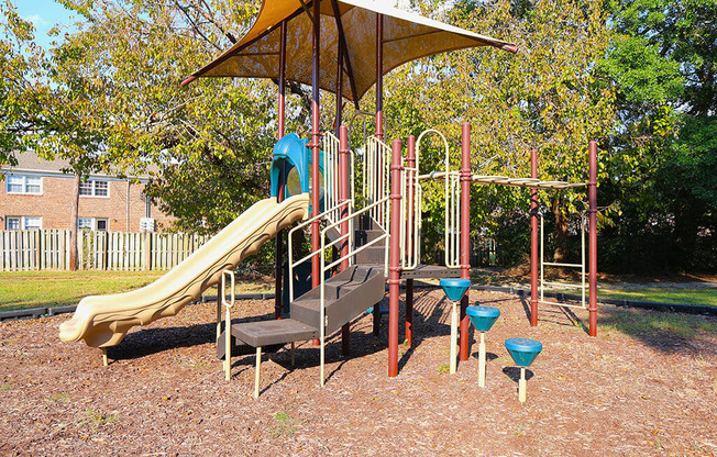 a playground with a slide and other playground equipment