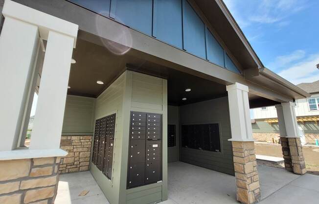 A building with a grey roof and a black mailbox.