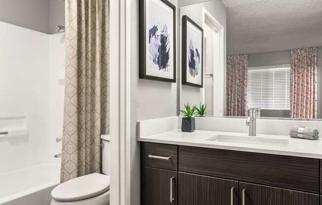 a bathroom with a toilet sink and bathtub in a 555 waverly unit