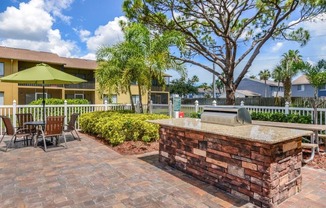 Outdoor grill with pool at Bay Club, Bradenton, Florida