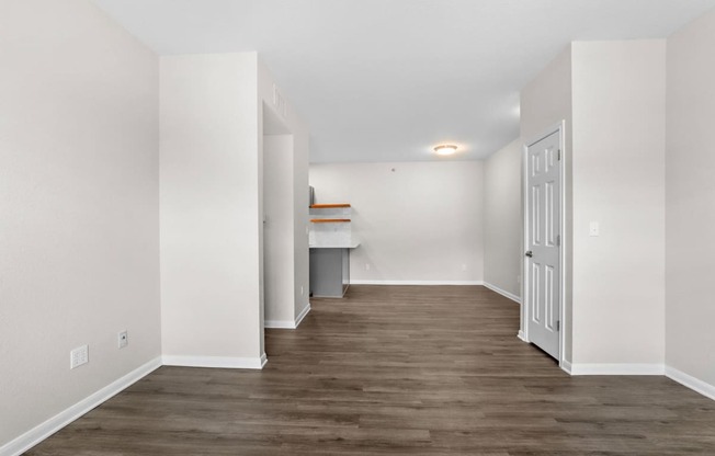 a renovated living room with white walls and wood flooring at Switchback on Platte Apartments, Colorado, 80120