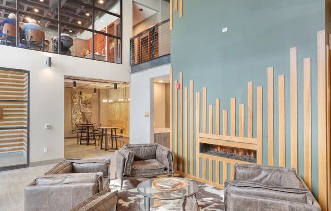 a large living room with couches and a fireplace