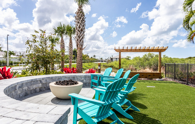 exterior fire pit with seating around it in daytime