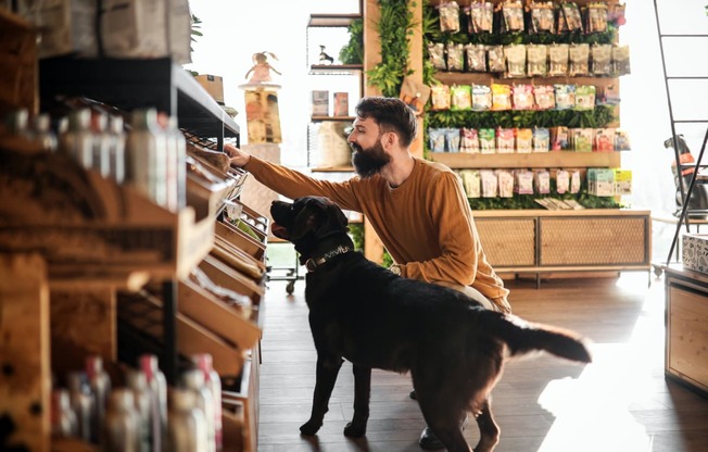 a man and his dog looking at food in a grocery store at North Grove, Riverside California  