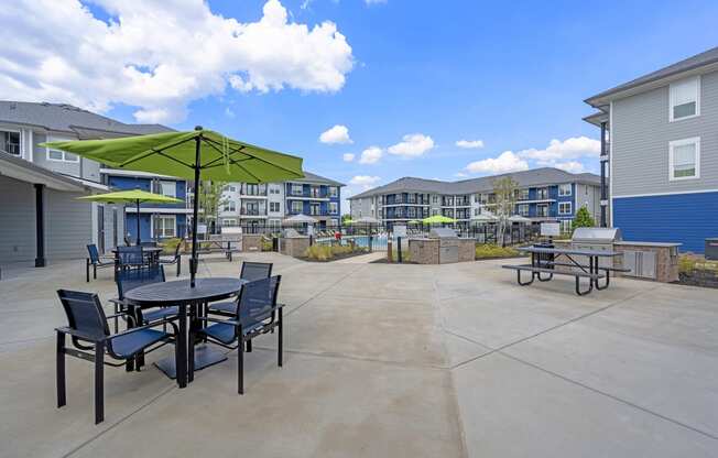 our apartments have a patio with tables and chairs and umbrellas