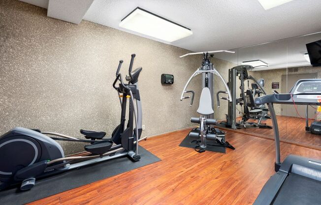 Apartments for Rent in North Hollywood - Community Fitness Center with Mirror Wall, Treadmill, Weights Machine and Elliptical.