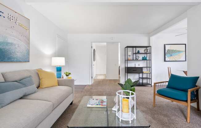 a living room with a couch and a glass coffee table