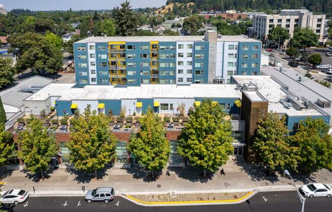 an aerial view of a building with trees in front of it