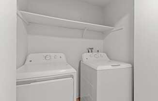 A small laundry room with a washer and dryer.