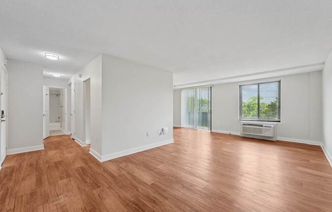 A room with wooden flooring and white walls at Riverside Apartments, Alexandria, Virginia