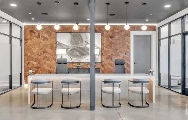 a kitchen and dining area with stools in front of a wood wall