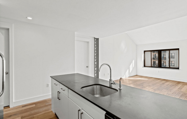 Experience a blend of style and functionality in this contemporary apartment kitchen.