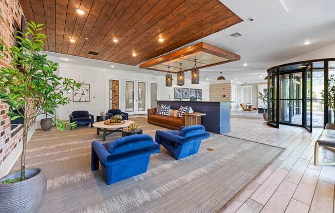the lobby or reception area of a house with blue chairs