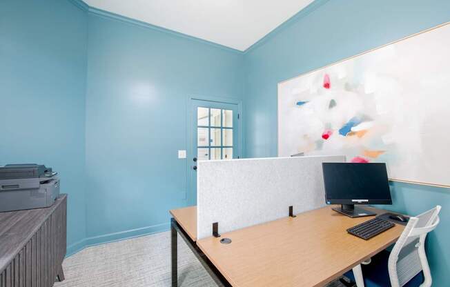 A room with a desk and a computer.