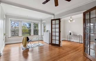 the living room has a hardwood floor and a large window at The Bryant at Oak Park I & II, Oak Park, 60302
