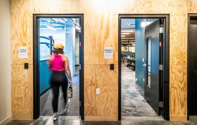 a woman running through a door in a building