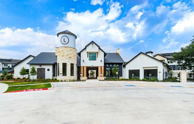 the exterior of a building with a parking lot and a clock tower at Legacy at Cibolo, Boerne