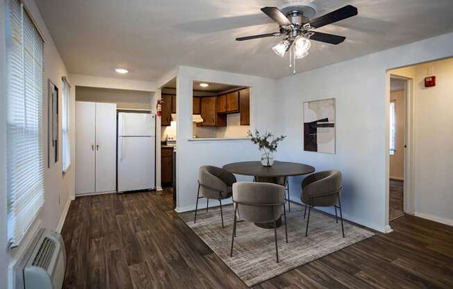 A dining room with a table and chairs.