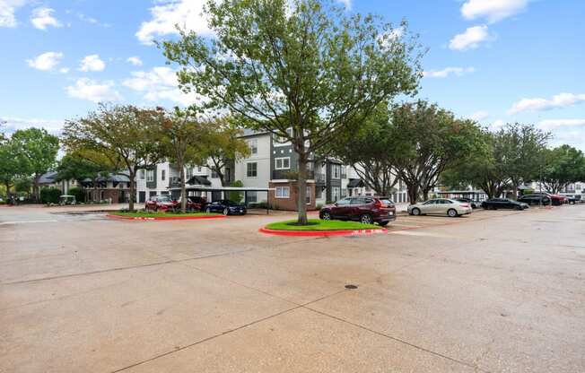 a parking lot with cars parked in front of a building at Mission Gate, Texas, 75024