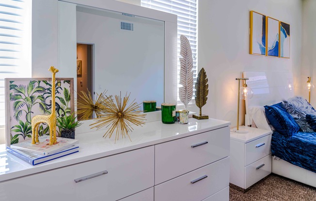 white dresser next to bed in master bedroom at turtle creek apartments