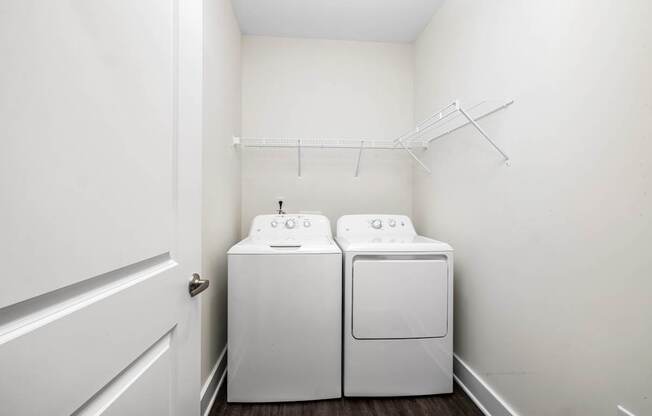 A small laundry room with a washer and dryer.