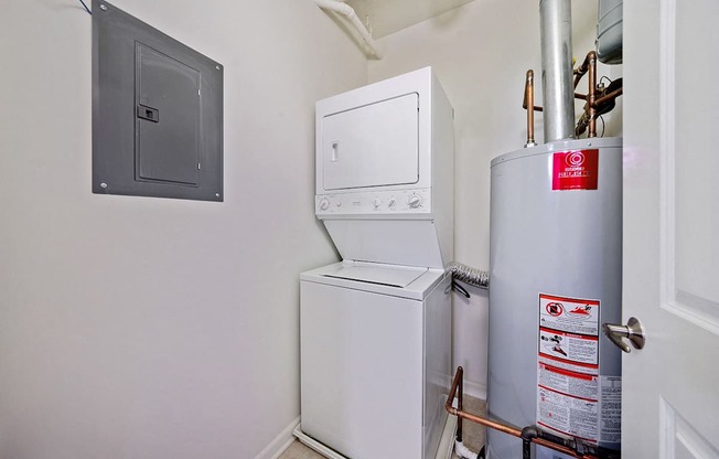 A white washing machine and dryer in a small room.