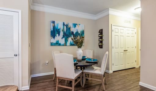 a dining room with a table and chairs and a painting on the wall at Echo at Lake Norman, Mooresville North Carolina