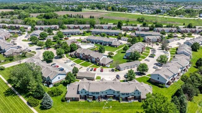 A bird's eye view of a residential neighborhood with houses and green lawns.