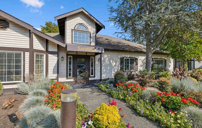 A house with a garden in front of it.