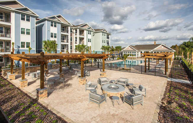 an outdoor patio with tables and chairs and a pool