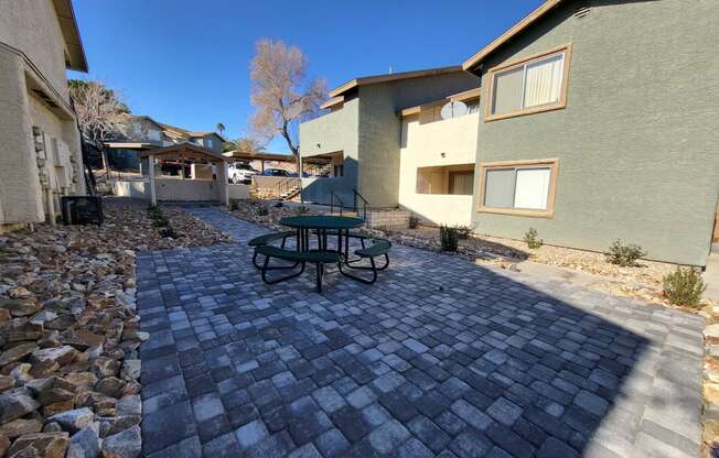 a patio with a picnic table in a courtyard